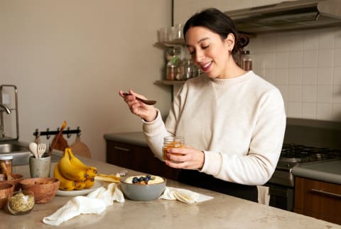 Woman preparing a healthy breakfast in the morning with an optimistic attitude and vibe