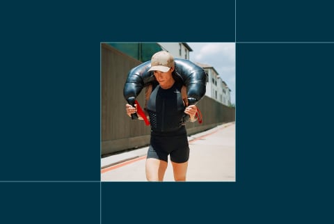 photo of gabrielle lyon rucking in weighted vest and bag, on blue background