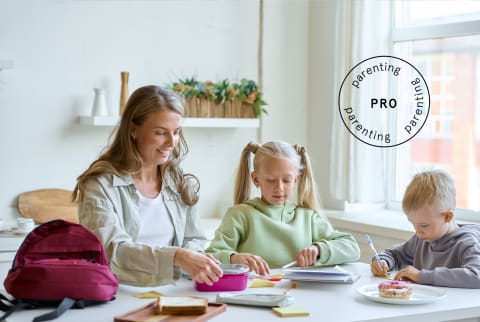 Mom packing school lunches with her kids