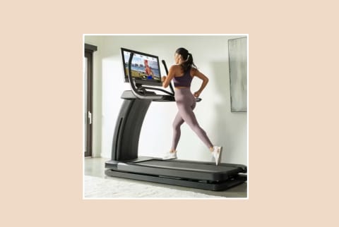 NordicTrack Elite Model with woman running on pink background