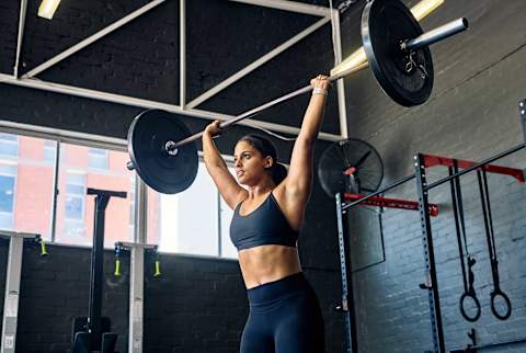 Woman lifting heavy weights Woman lifting heavy weights