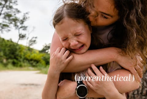 Parenthetical - child crying in mother's arms