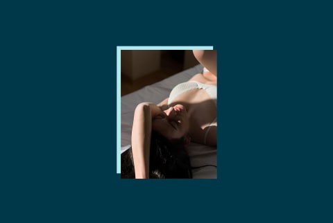photo of woman with brown hair laying in bed on blue background photo of woman with brown hair laying in bed on blue background