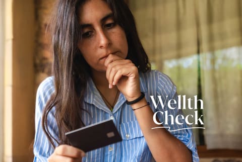 Young woman deciding which credit card to use