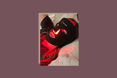 bon charge red light mask on woman's ace while lying down with red glowing on nose and mouth