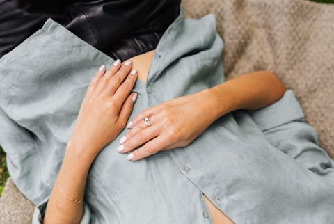 woman lying on back with hands on stomach 