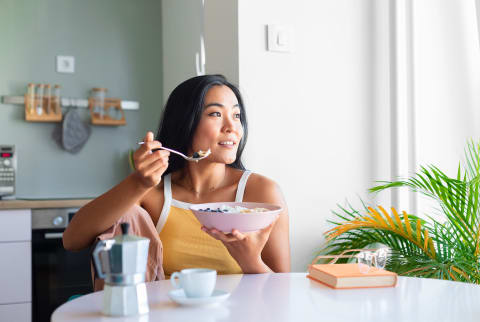 Asian Woman Having Breakfast At Home