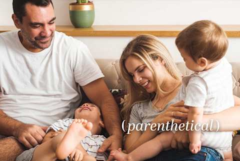 Happy Family Of Four Cuddling And Laughing