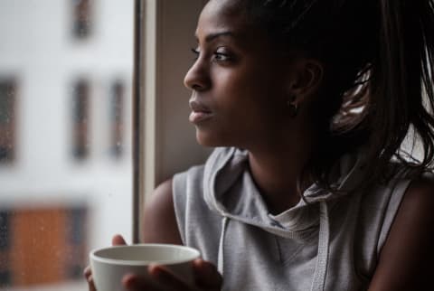 Young Woman Looking Through The Window