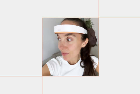 photo of editor wearing mendi headset on grey background