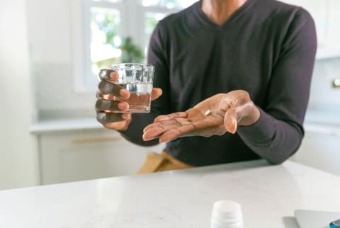 Black man taking medication