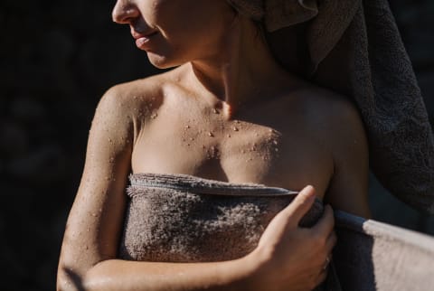 a woman wraps herself in a towel after a shower