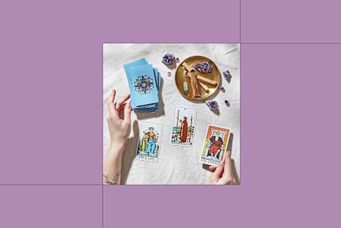 image of tarot cards on table on purple background