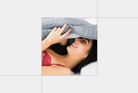 close up of woman laying in bed under the covers