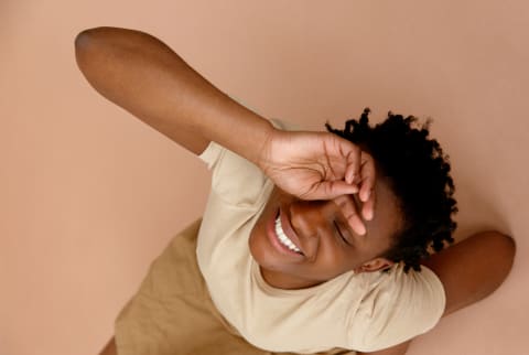 Young black woman touching her forehead