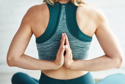 Woman doing yoga and meditation to relieve pain