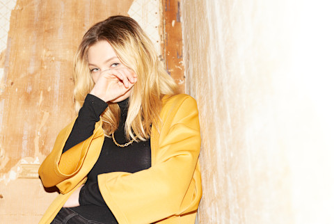 Blonde Girl In Yellow And Black Covering Her Face With Hand Over Blonde Girl In Yellow And Black Covering Her Face With Hand Over