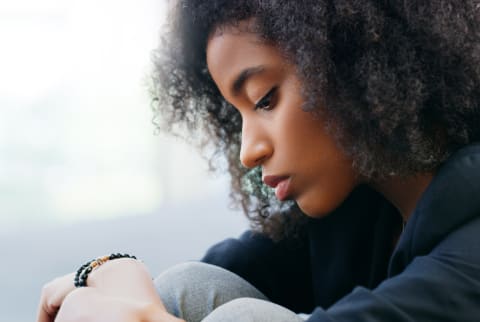 young black woman looking depressed and sad