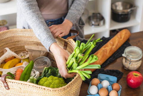 Person unloading her produce and shopping Person unloading her produce and shopping