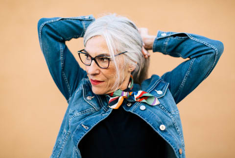 Cool older woman tying up her hair