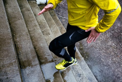 Athlete Climbing A Wet Staircase On A Rainy Day