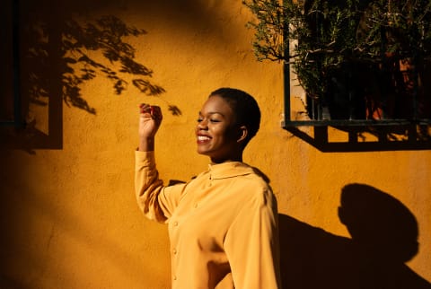 Black woman looking into the sun aspirationally