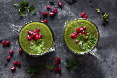 Green smoothie cocktail with pomegranates