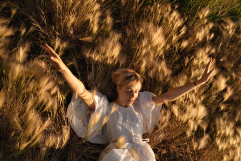 Young woman in a grassy field