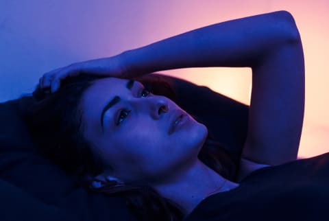 Woman lying in bed awake