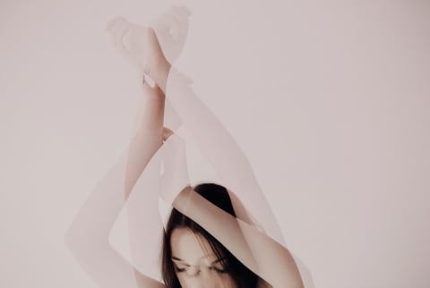 abstract photo of woman holding arms up