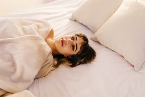 Young white woman sleeping in bed