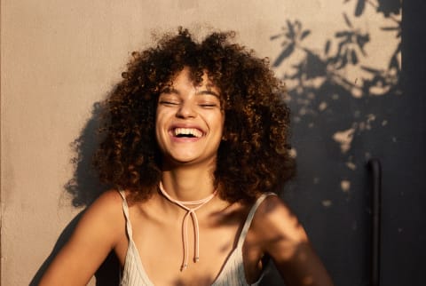 woman laughing in the sun and shadows