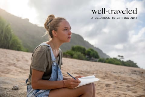 woman journaling on beach