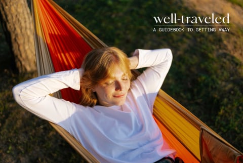 Woman relaxing on a hammock during golden hour - Well Traveled franchise