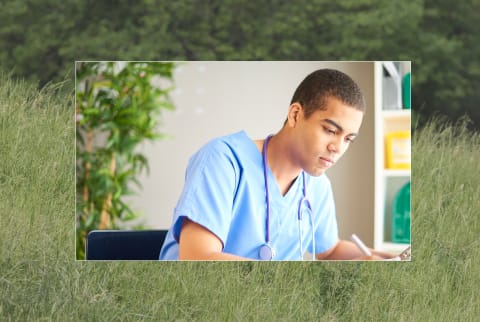 Medical student with background of green grass