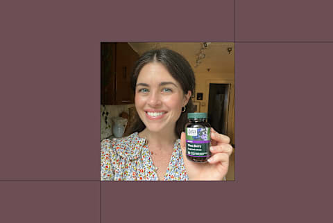 Author (tester) in room holding bottle of gaia herb vitex supplement up to camera in right hand