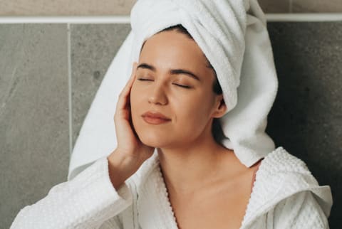 Woman In A Bathrobe and Towel Enjoying a Relaxing Moment
