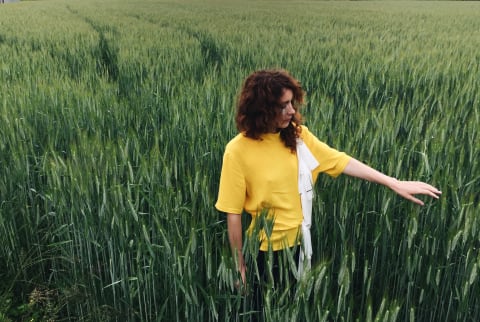 Lonely single woman in a field of tall grass