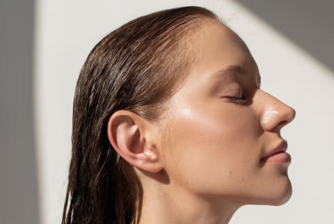 Woman with glowing skin and wet hair