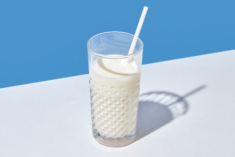 Glass Of Fresh Milk With Paper Straw