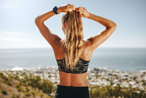 Back of a Woman in Fitness Clothing, Adjusting Her Ponytail