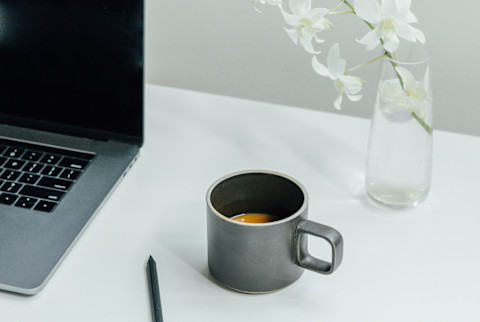 Modern Work Desk With Laptop Open And Black Coffee Mug Modern Work Desk With Laptop Open And Black Coffee Mug