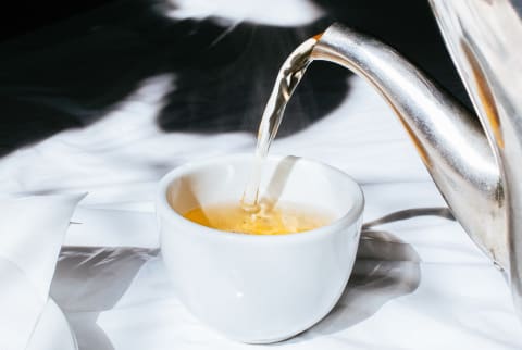 Herbal Tea Being Poured into a Cup