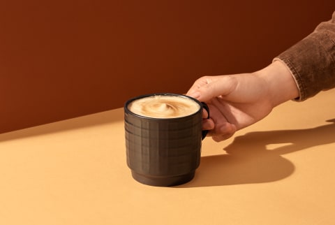 Hand Holding a Cappuccino 