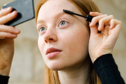 Young Woman Putting On Make-Up