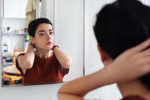 Brunette Looking At The Mirror