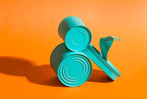 Painted Blue Tin Cans on an Orange Background