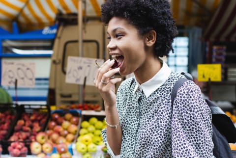 Woman eating food at a market