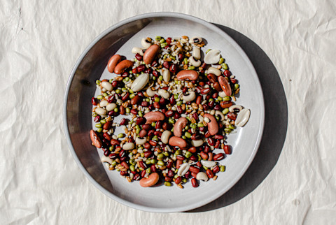 chinese eight treasure congee — kidney beans, adzuki beans, green beans, peanuts on ceramic plate