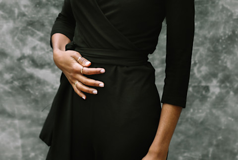 Young Woman With Hand on Stomach